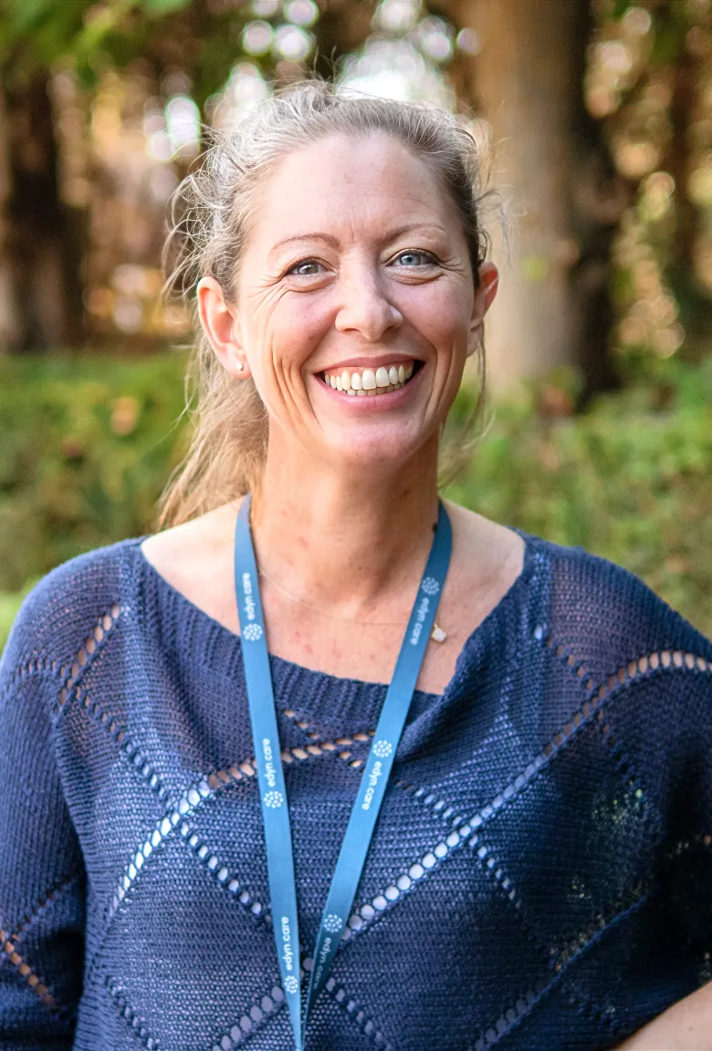 An Edyn carer smiling outdoors
